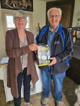 two volunteers holding up a box with a light inside
